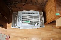 Top view of the Gree window mount air conditioner installed in a window frame showing its size and placement.