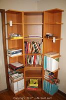Corner shelving unit seen from front with books and items stored on shelves