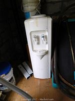 Front view of white Water Land water cooler with two taps.