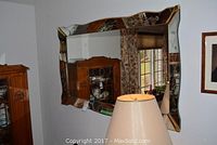 Front angled view of decorative beveled wall mirror showing etched floral details