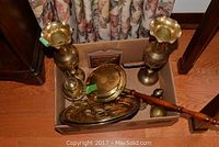 Full view of the box containing all brass items: two vases, teapot, bell, tray, and bellows.