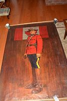 Full view of one poster showing a Mountie standing in front of Canadian flag, measuring 73x48 inches