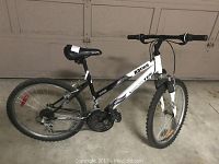 Side view of Raven Sportek youth bike showing frame, tires, chain and pedals.