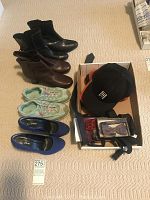 Photo showing two pairs of size 9 boots (black and brown), youth size 5 mint green running shoes, blue high-heeled pumps, six baseball caps, and box with ties and framed item.
