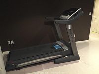 Side profile of FreeMotion T30 treadmill showing overall frame and running deck
