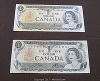 Front view of both 1973 Canadian one dollar bank notes showing Queen Elizabeth II portrait and serial numbers.