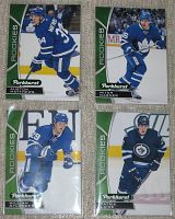 Front view of 4 rookie hockey cards Auston Matthews, William Nylander, Mitch Marner, Patrik Laine in Toronto Maple Leafs and Winnipeg Jets jerseys