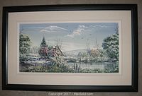 Full view of the framed landscape painting showing a cabin next to a river with trees and birds in the background.