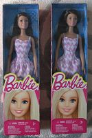 Photo of two brand new Barbie dolls in original boxes, each wearing pink and white chevron patterned dresses.