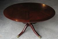 Full side image showing the pedestal base with three curved legs and brass claw feet