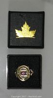Photo showing the Montreal 1930 Stanley Cup Replica Ring inside its black presentation box with a gold maple leaf symbol on the inside of the box lid.