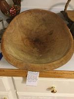 Top view of the vintage oval wooden bread bowl showing handle indentions and wood grain with some darkened marks inside.