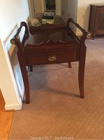 Front view of the brown wooden basset side table with drawer and side handles