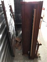 Knabe grand piano viewed from the top showing the keyboard and wooden case with some fading.
