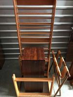 Wooden CD rack, pedestal, luggage rack, and log carrier frame grouped together, showing overall condition and size.