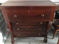 Full front view of high chest of drawers showing the overall condition, drawer knobs, and curved legs.