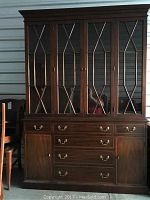 Full front view of two-piece china cabinet (hutch atop base) in cherry finish