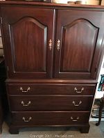 Front view of cabinet showing two doors and three drawers.