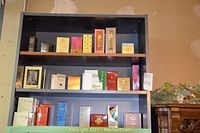 Three‐shelf display of sealed boxed perfumes and colognes