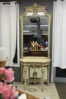 Full view of antique-style hall stand console with large mirror showing overall condition, decorative details, and detached decorative trim piece on floor.