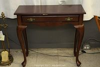 Full frontal image of the Bombay Company sofa table, showing single drawer and Queen Anne style legs.