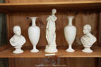 Photo of 2 busts, 2 vases, and 1 statue displayed on wooden shelf, showing size, shape, and color of pieces.