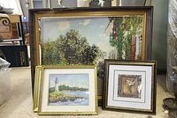 Overview of lot showing large landscape painting on canvas with frame and three smaller framed prints of different scenes including lighthouse and floral prints.