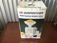 Front photo of the Sunpentown multi-function grinder/juicer box showing product image and brand CL-010.