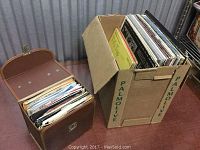 Photo showing two boxes filled with vinyl records in different sizes.