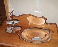 Pair of 1960's Kromex chrome serving trays on wooden surface, showing overall look of two trays