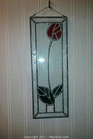 Frontal photo of the stained glass tulip piece showing metal frame and colored glass elements.
