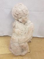 Front and side view of the textured sculpture showing the boy holding the dog.