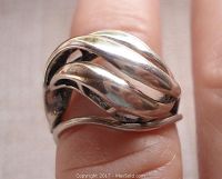Front angle close-up showing domed shape and flowing open work silver design on the vintage ring.