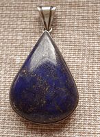 Front view of teardrop-shaped lapis lazuli pendant with pyrite inclusions in sterling silver setting.