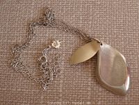 Sterling silver and 10K gold leaf pendants on sterling chain, showing front side of pendants and chain with maple leaf tag