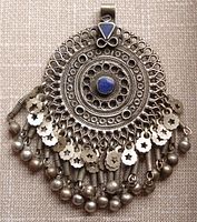 Front view of the intricate large round pendant with open filigree design and lapis lazuli stones, showing the detailed dangles and ornamental elements.