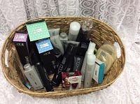 Wicker basket with assorted boxed and unboxed hair and beauty products