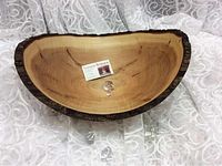17-inch wave-edge wooden bowl with natural bark-edge, displayed with Stinson Studios card
