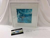 Framed square painting by Beth tenHove on white backdrop