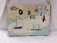 Front view of “Kingston” collage mixed media painting showing map background, sailing ships, buildings and figures