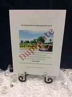 Printed voucher detailing the wine tasting experience displayed on an iron scroll stand with glass votive holders