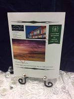 Printed gift certificate for one night stay and golf rounds displayed on decorative stand