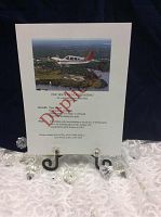 Printed gift certificate showing Piper Arrow flying over Kingston with donation stamp