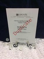 Printed HydraFacial gift certificate displayed on black easel with decorative crystal accents