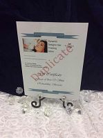 Photo of the Esthetics Gift Certificate for three Skin Remodeling System treatments, displayed on a stand with clear decorative accents.