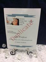 Printed certificate with blue banner headers, red “Delicate” watermark, displayed on a black easel with crystal decorations