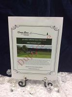 Photo of the Camden Braes 2 green fees and power cart gift certificate, displayed on stand with decorative crystals.