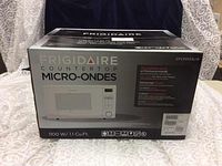 Frigidaire countertop microwave oven box showing model, power rating, and capacity.