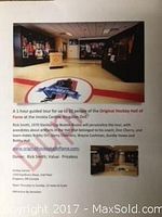 Photo of the interior of the Original Hockey Hall of Fame at the Invista Centre, Kingston, showing exhibit displays and the logo on the floor.