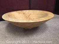 Side view of a large maple woodturned bowl showing exterior and wood grain